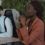 Colleagues in a business meeting with diverse backgrounds discussing project plans.